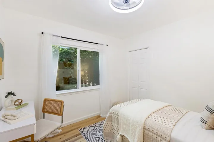 Bedroom featuring wood finished floors and a closet
