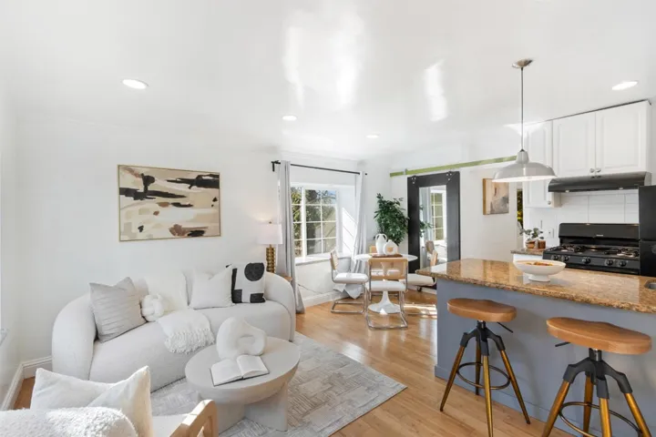 Living area with light wood-style flooring and recessed lighting