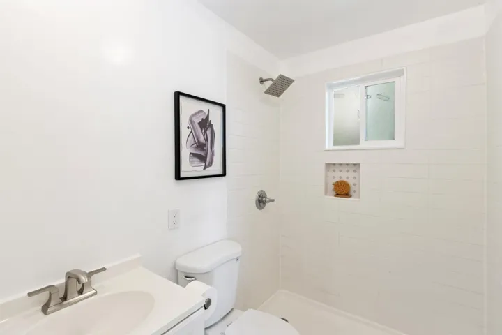 Bathroom with vanity and a tile shower