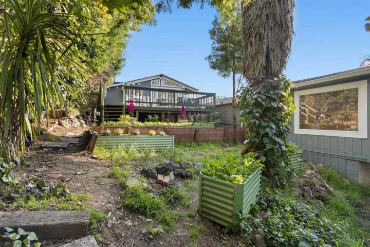 View of yard featuring a garden and a wooden deck