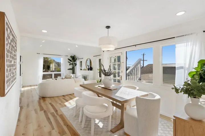 Dining space featuring recessed lighting, vaulted ceiling, light wood finished floors, and a fireplace