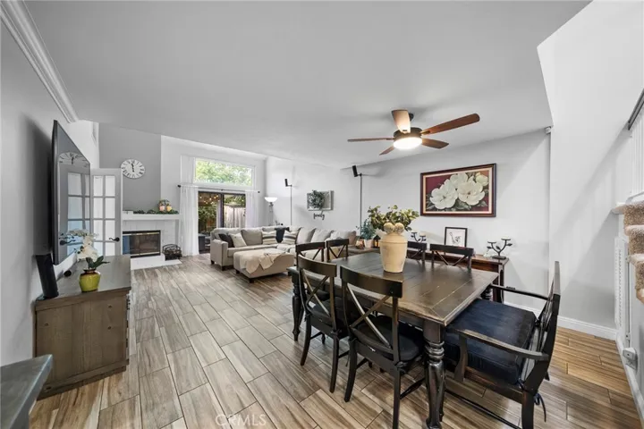View of the large open dining area to the spacious living room leading out to the enclosed patio.