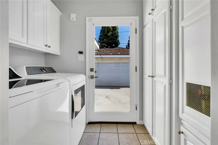 Interior Laundry Room with Cabinets and Clear Glass Exterior Rear Exit Door.