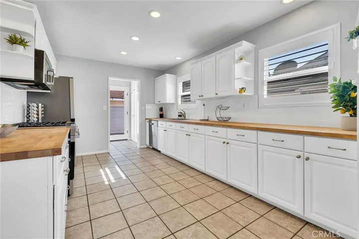 Newer Kitchen Cabinets & Wood Butcher Block Counter Tops. Recessed Lighting & Window Shutters.