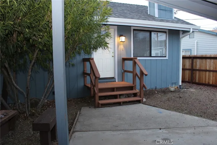 Front porch and carport area with storage.
