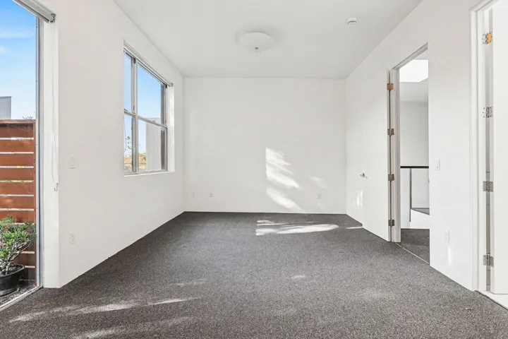 Unfurnished bedroom with dark carpet