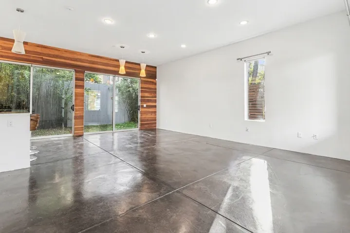 Empty room featuring concrete floors and recessed lighting
