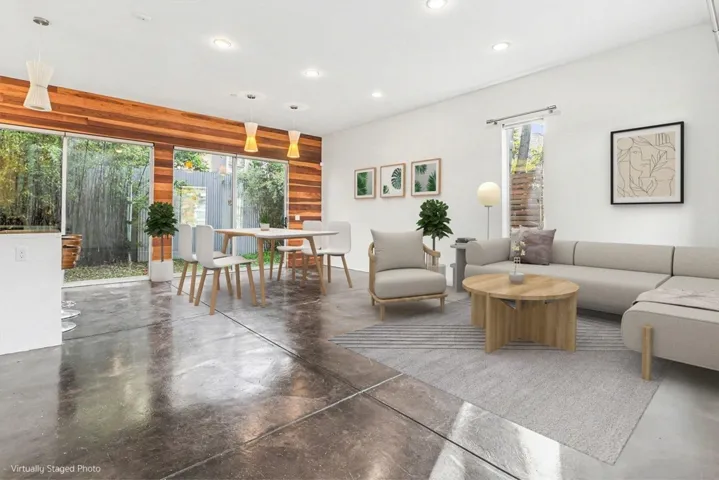 Living area featuring finished concrete flooring and recessed lighting