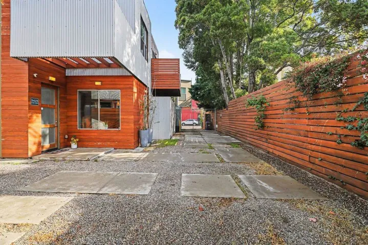 View of property exterior featuring a gate