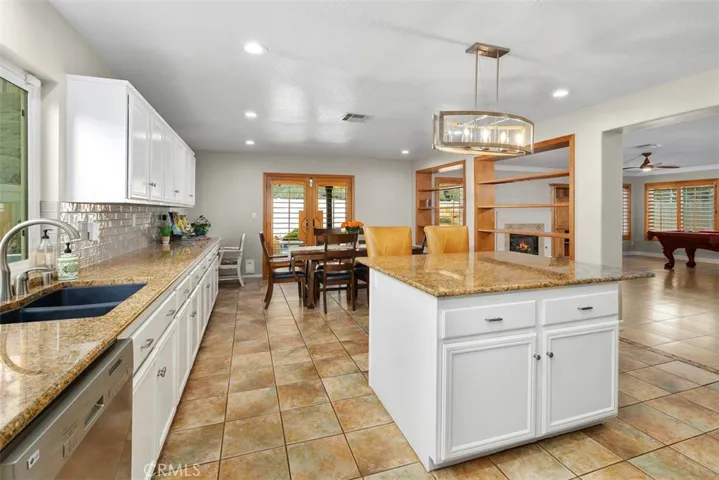 Long shot of this Spacious Kitchen with Direct Access to the Outdoor Living Space.