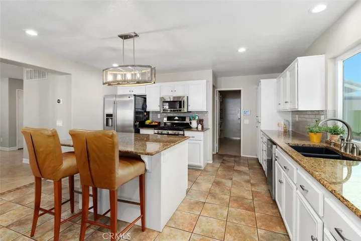 Open Concept Kitchen with Abundant Counter Space, Walk-in Panty and Laundry Room.