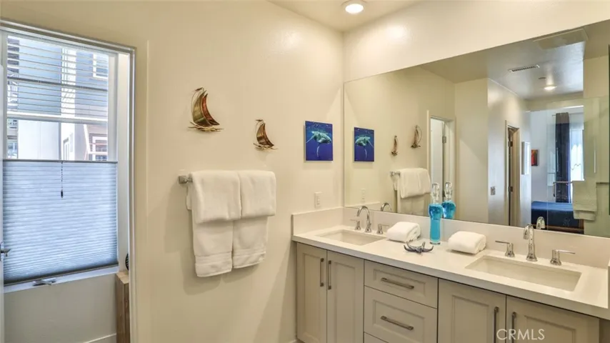 Primary bedroom with en-suite bathroom and dual closets.