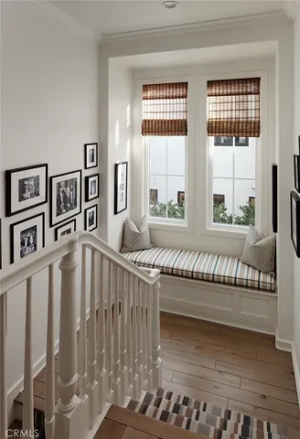 Stairway with wood flooring, carpet runner and bench