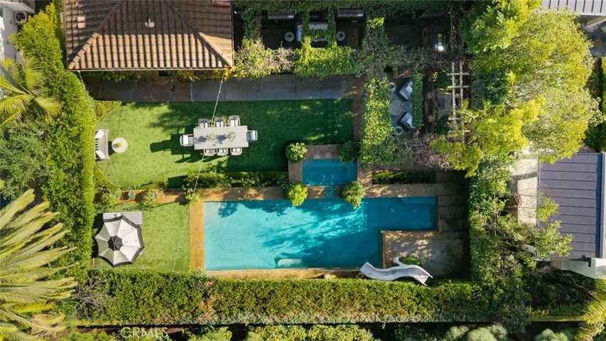 Aerial View of backyard: dining, lounge area, loggia, fireplace, bbq,  saltwater pool and spa