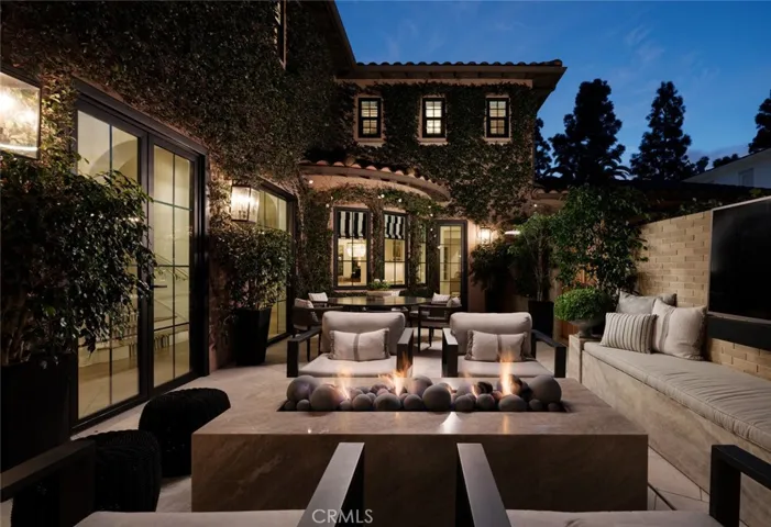 Enclosed outdoor terrace with Taj Mahal quartzite fire pit and dining area