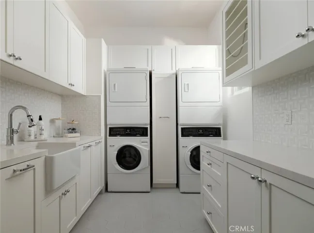Laundry/Utility Room:  two pairs of stacked washer and dryers, drying racks, wine and additional refrigerator, sink and generous storage