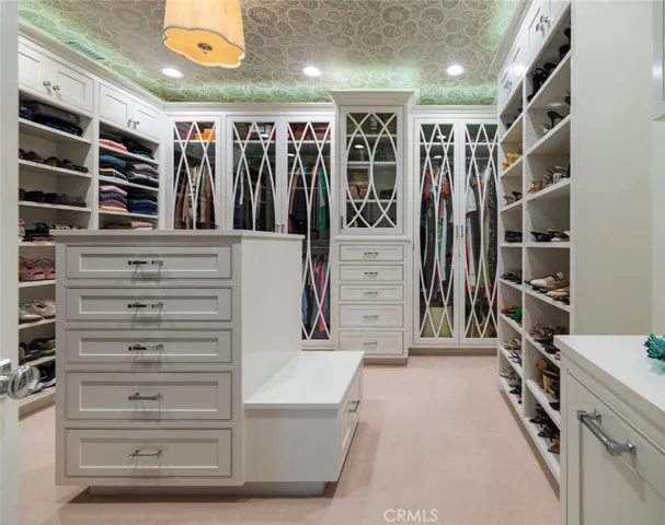 Upstairs: Primary custom oversized walk-in closet with a boutique style design