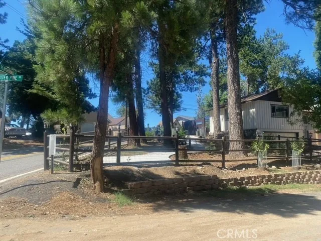 Corner pie shaped lot on Playground Dr.,  and Coulter Pine Drive.