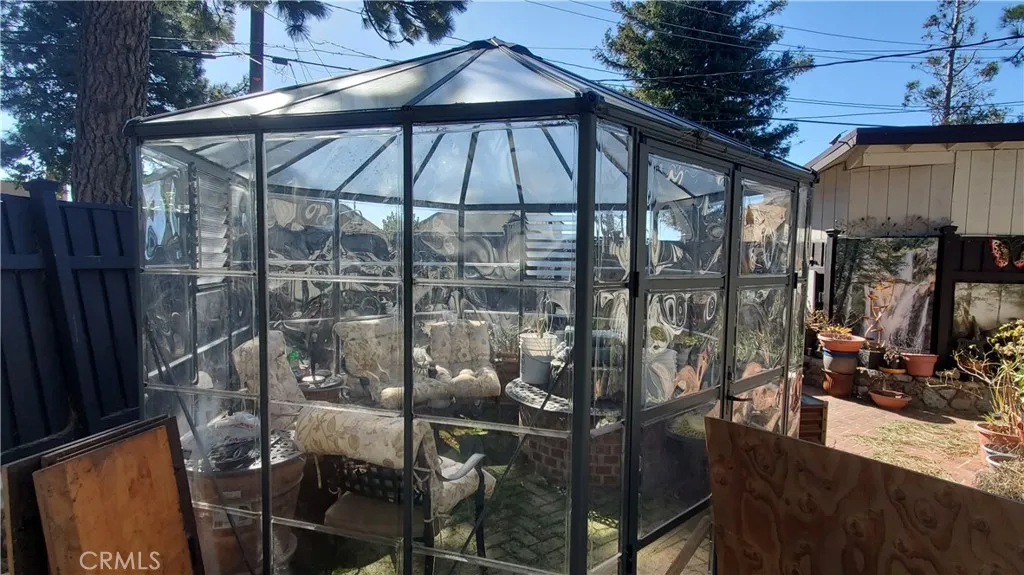 This green house is in the patio of the garage studio.