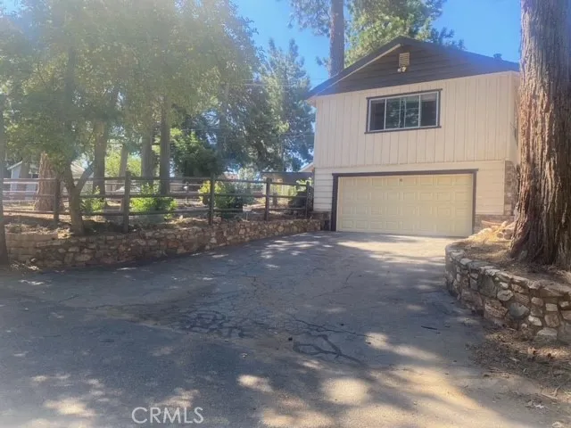 This is the back street entrance on Coulter Pine Dr.  The second level of this garage is the 3rd unit that rents for 1600/mo including utilities and is currently occupied.