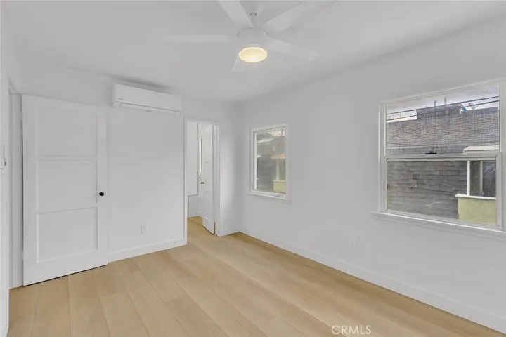 Bedroom view of window and entrance to the bathroom
