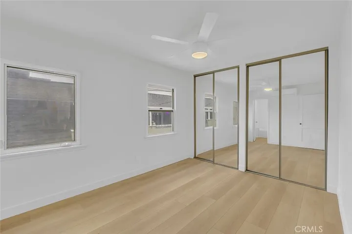 Bedroom view of windows and closet doors