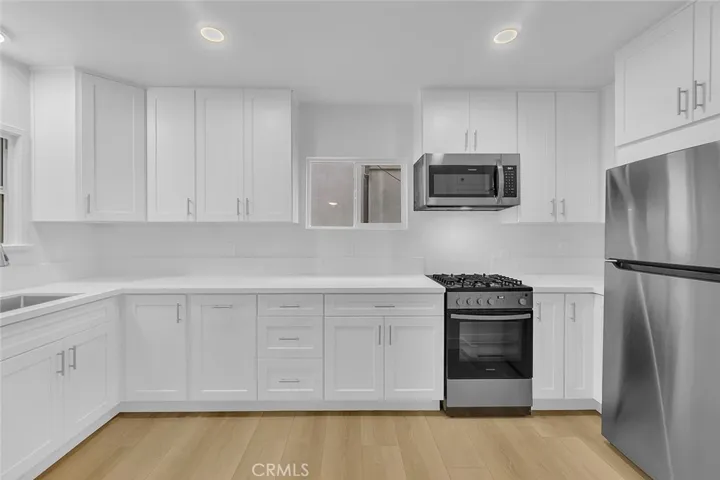 Kitchen view of the new refrigerator & range