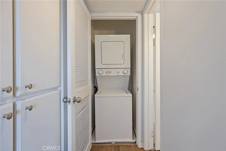 includes stackable washer & dryer in the hallway