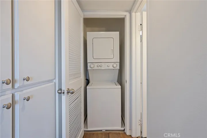 includes stackable washer & dryer in the hallway