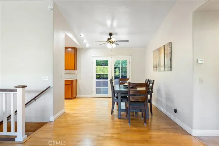 The dining area is conveniently located between the living room and kitchen for easy every day living. The French doors access the back patio.