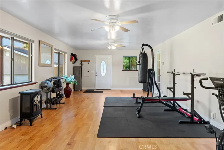 Half of the bonus area is currently configured as a work out area with hardwood floors.