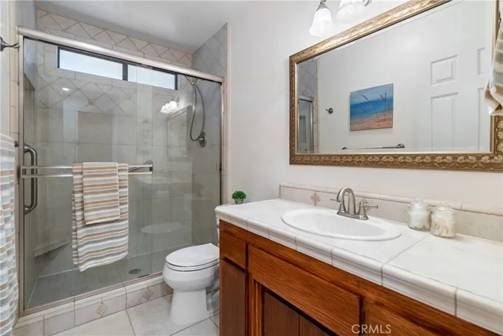 The bathroom offers wonderful tile work, walk-in shower and large vanity.