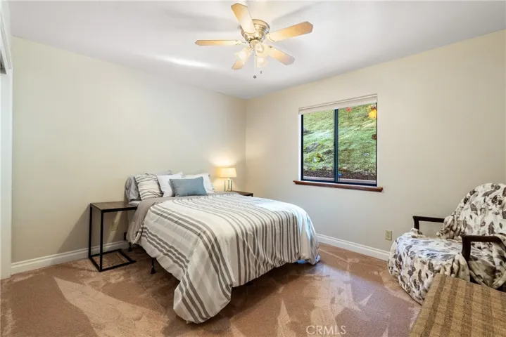 Bedroom 3 also features plush carpet and a ceiling fan.