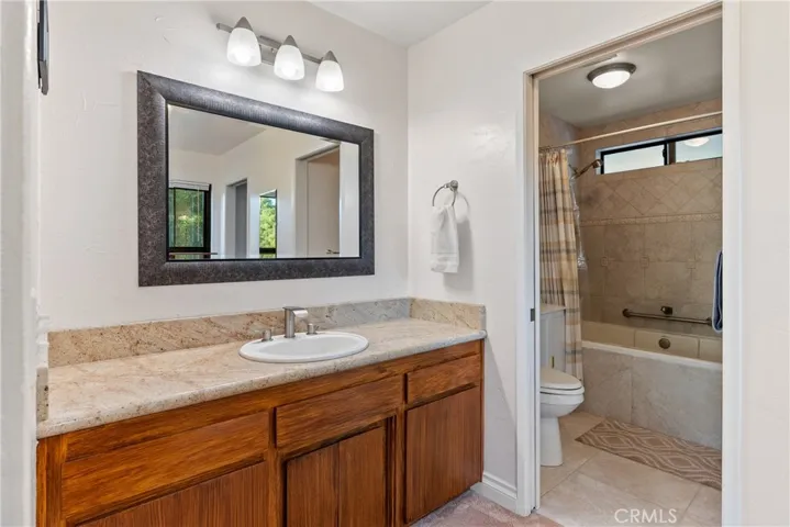 The ensuite bathroom has dual, granite topped vanities.
