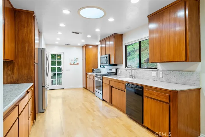The large kitchen boasts granite countertops, brilliant lighting and a solar tube.
