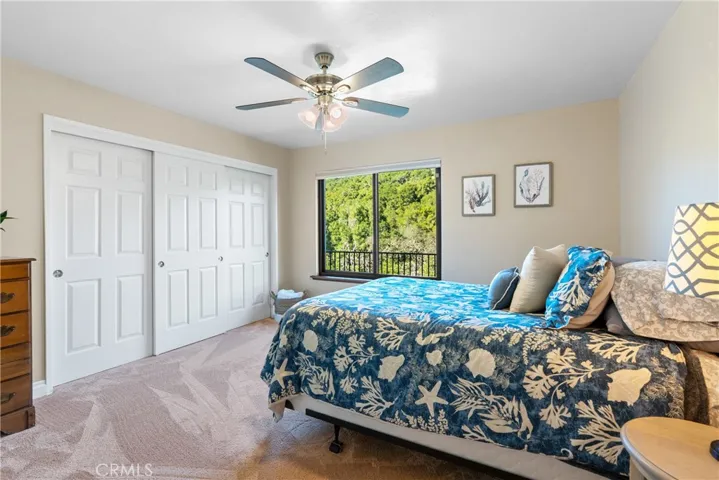 Bedroom 2 has plush carpet, a ceiling fan and a large reach-in closet.