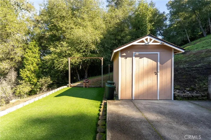Behind the garage is a handy storage shed and area with artificial grass.