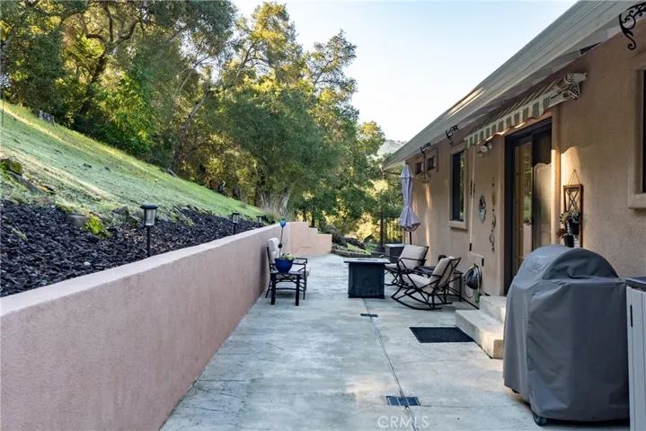 Spacious back patio offers ample room for entertaining or simply relaxing and taking in the surroundings.