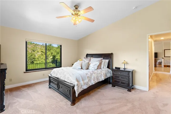 The vaulted ceilings give the bedroom a light and airy feel.