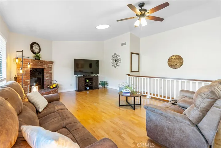 The living room features hardwood floors, vaulted ceilings and solar tubes to bring in the natural light.