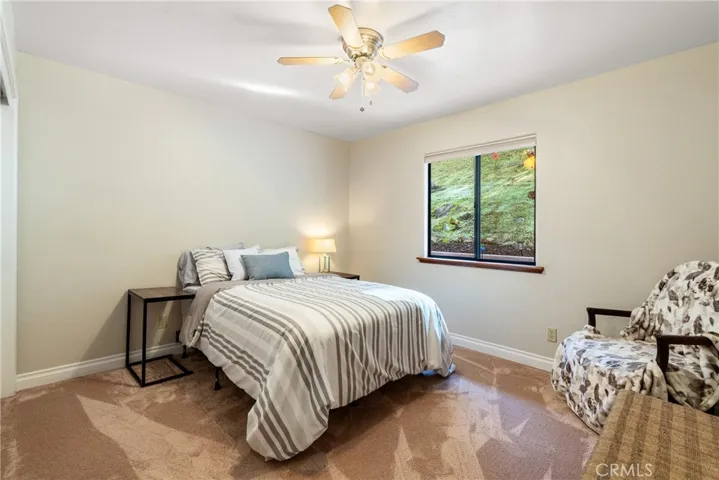 Bedroom 3 also features plush carpet and a ceiling fan.