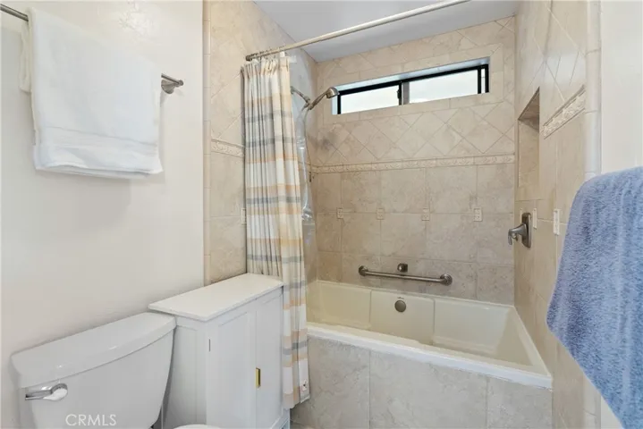 The ensuite features an extra deep soaking tub/shower combination with tile surround.