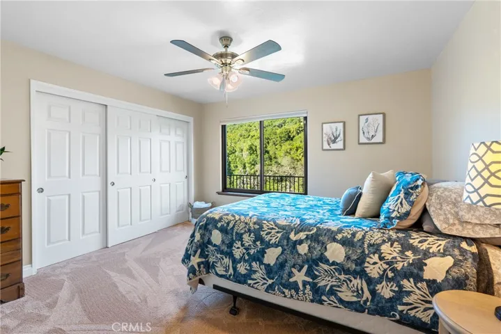 Bedroom 2 has plush carpet, a ceiling fan and a large reach-in closet.