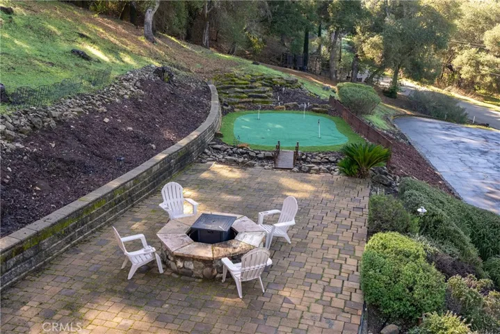 The brick paver patio hosts a firepit and artificial turf putting green which is sure to provide hours of fun!