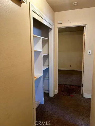 Hallway with large linen  closet