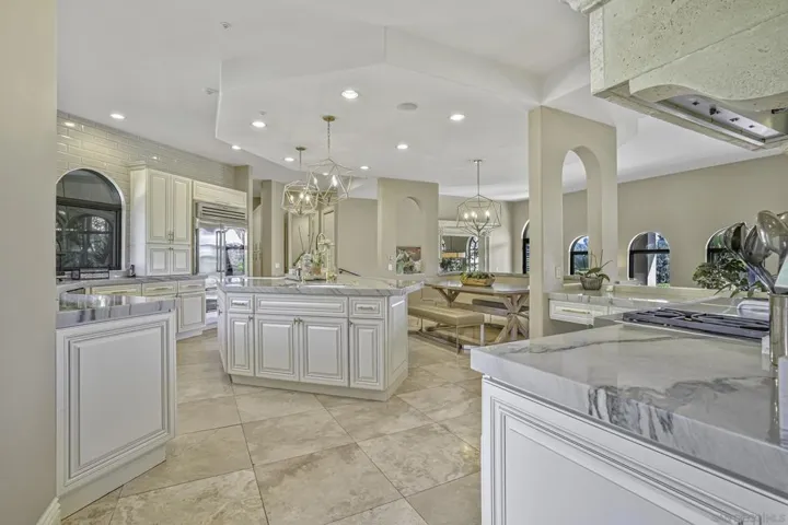 Gorgeous remodeled kitchen with new cabinetry, exotic quartzite counter tops, top of the line appliances and fixtures, and designer lighting.