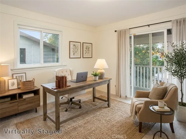 Three additional light-filled bedrooms with sparkling windows, ample closet space with mirrored wardrobe doors, and wall-to-wall carpet. One bedroom includes sliding glass doors opening to an expansive covered balcony and can easily function as an office or upstairs den. Virtually staged/enhanced photo