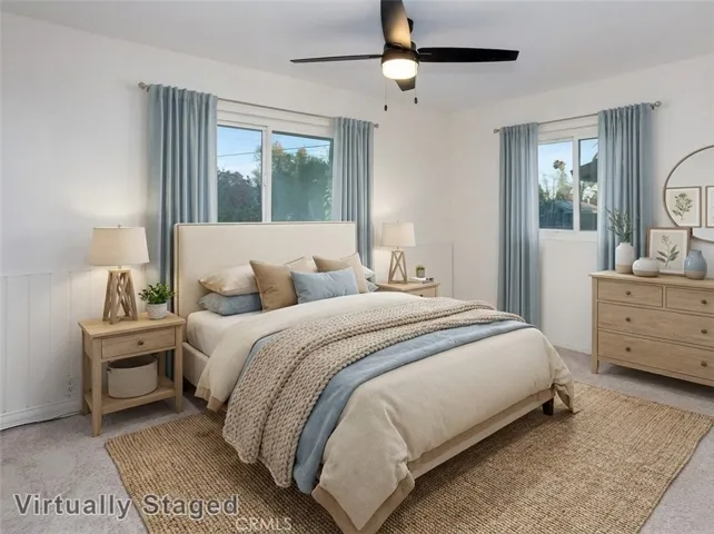 Three additional light-filled bedrooms with sparkling windows, ample closet space with mirrored wardrobe doors, and wall-to-wall carpet. One bedroom includes sliding glass doors opening to an expansive covered balcony and can easily function as an office or upstairs den. Virtually staged/enhanced photo