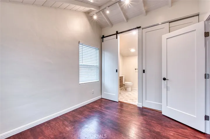 Bedroom with barn door into bathroom