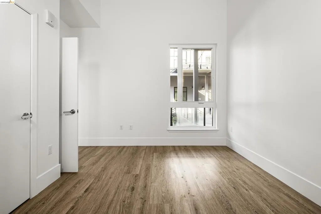 Empty room featuring wood finished floors and baseboards